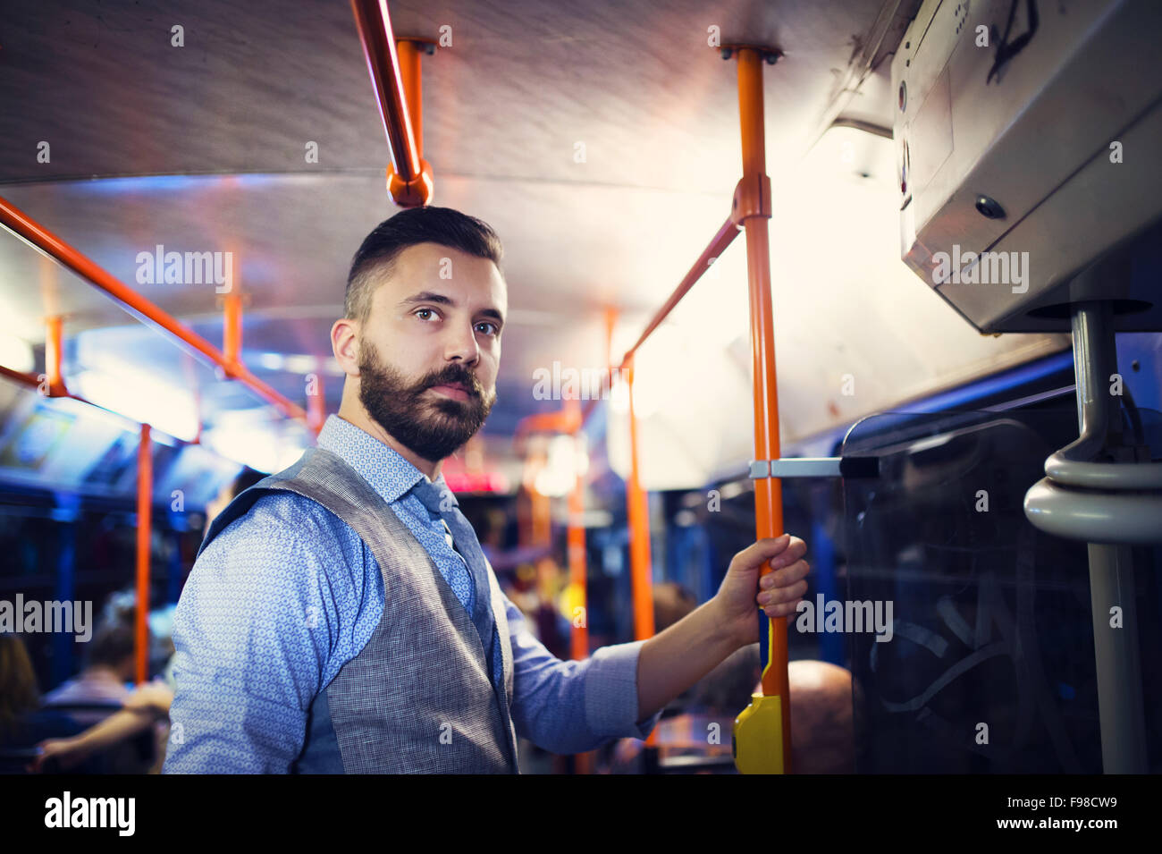 Handsome hipster modern man traveling by tram in night Stock Photo