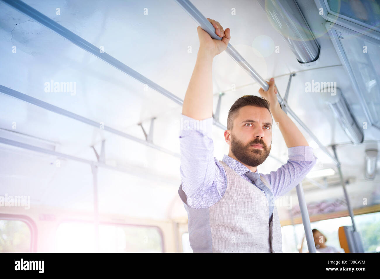 Handsome hipster modern man traveling by tram in town Stock Photo