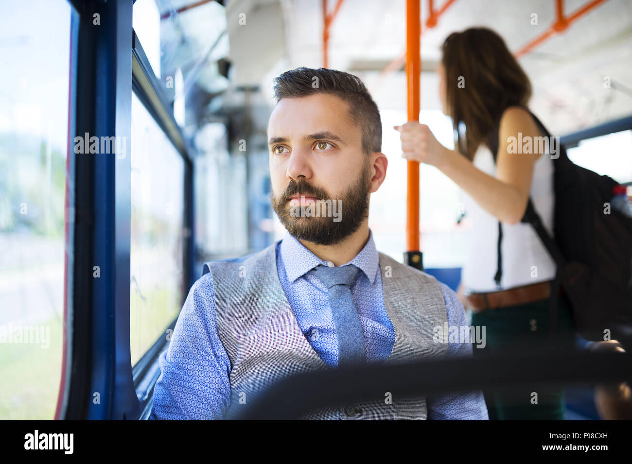 Handsome hipster modern man traveling by tram in town Stock Photo