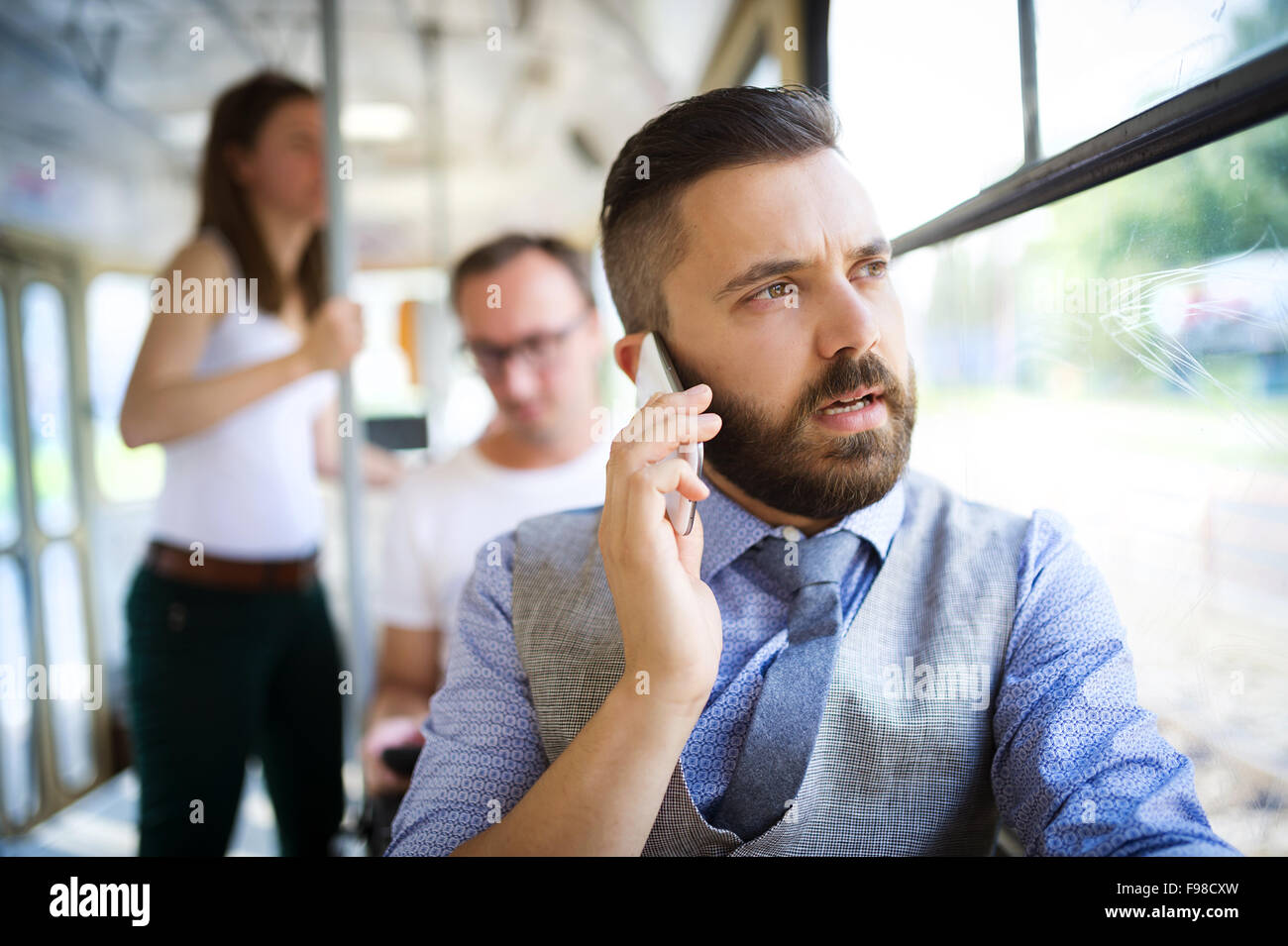 Handsome hipster modern man calling by mobile phone in tram Stock Photo