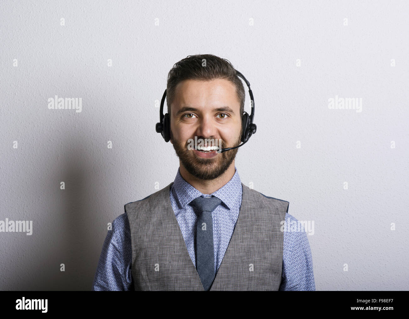 Call center operator isolated on white. Young handsome hipster man with ...