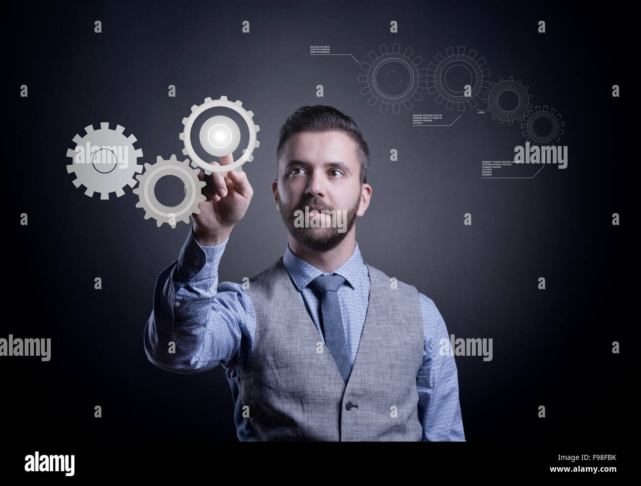 Hipster businessman working on virtual interface with cogwheels Stock Photo