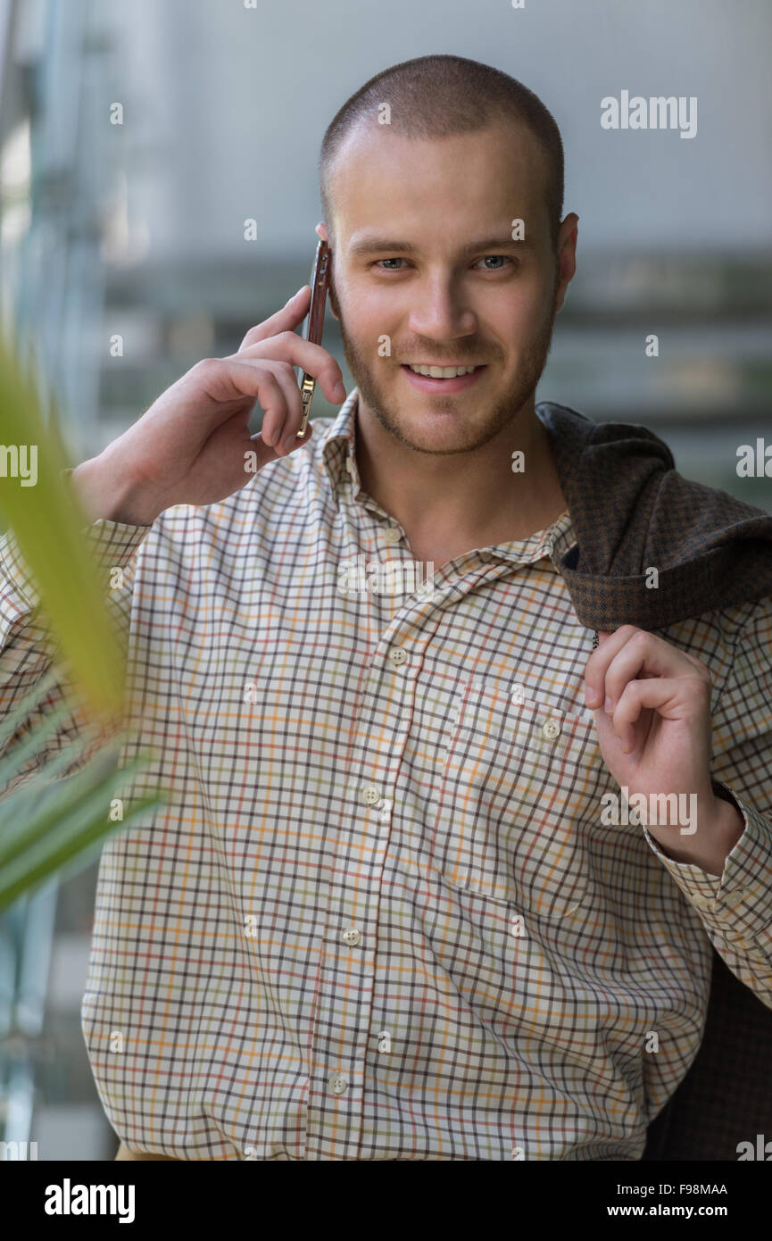 Handsome stylish businessman speaking on the phone in office Stock Photo