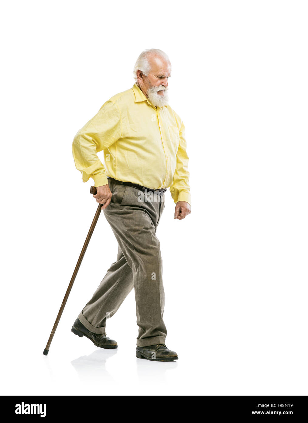 Old active bearded man walking with cane isolated on white background Stock Photo