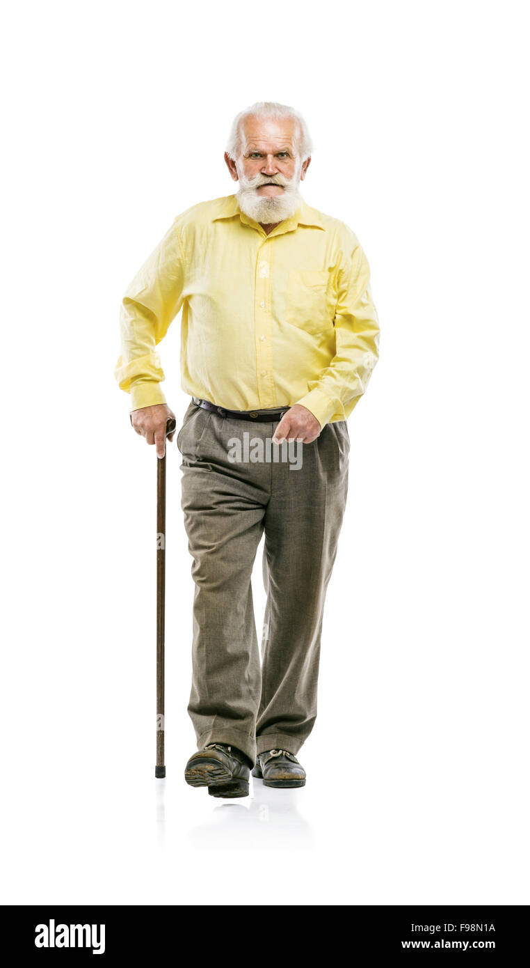 Old active bearded man walking with cane isolated on white background Stock Photo