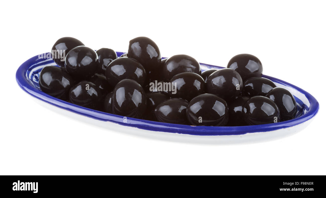 Olives black watered with olive oil in a bowl isolated on a white ...