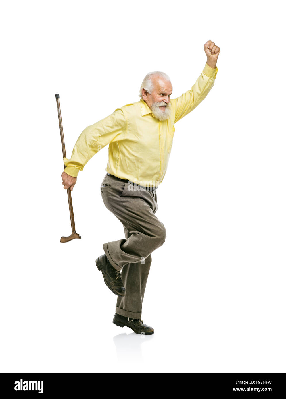 Happy old active bearded man jumping with cane in his hand isolated on white background Stock Photo