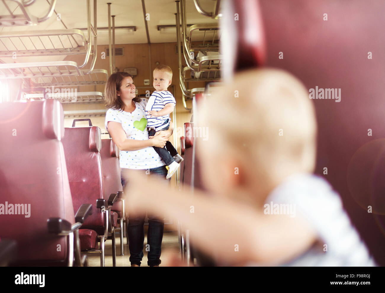 Family with two children travel in retro train. Stock Photo