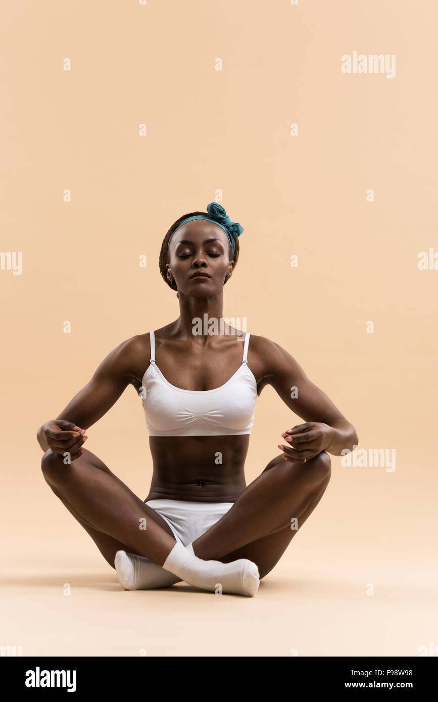 Young African woman in the lotus meditation position doing yoga Stock ...