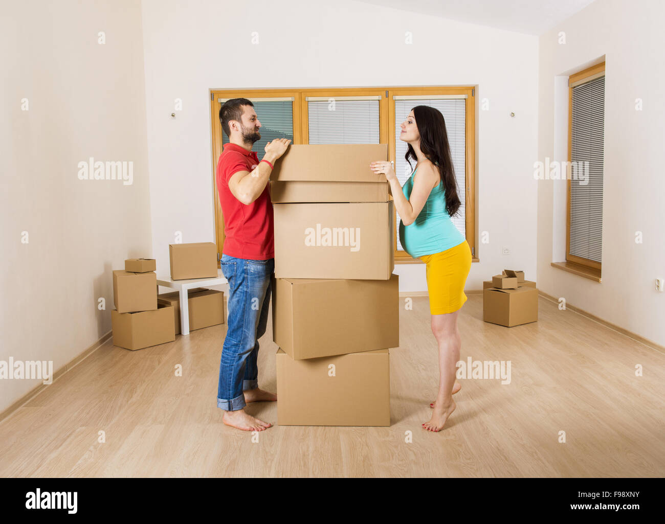 Pregnant mother and handsome father are going to move in to new house ...