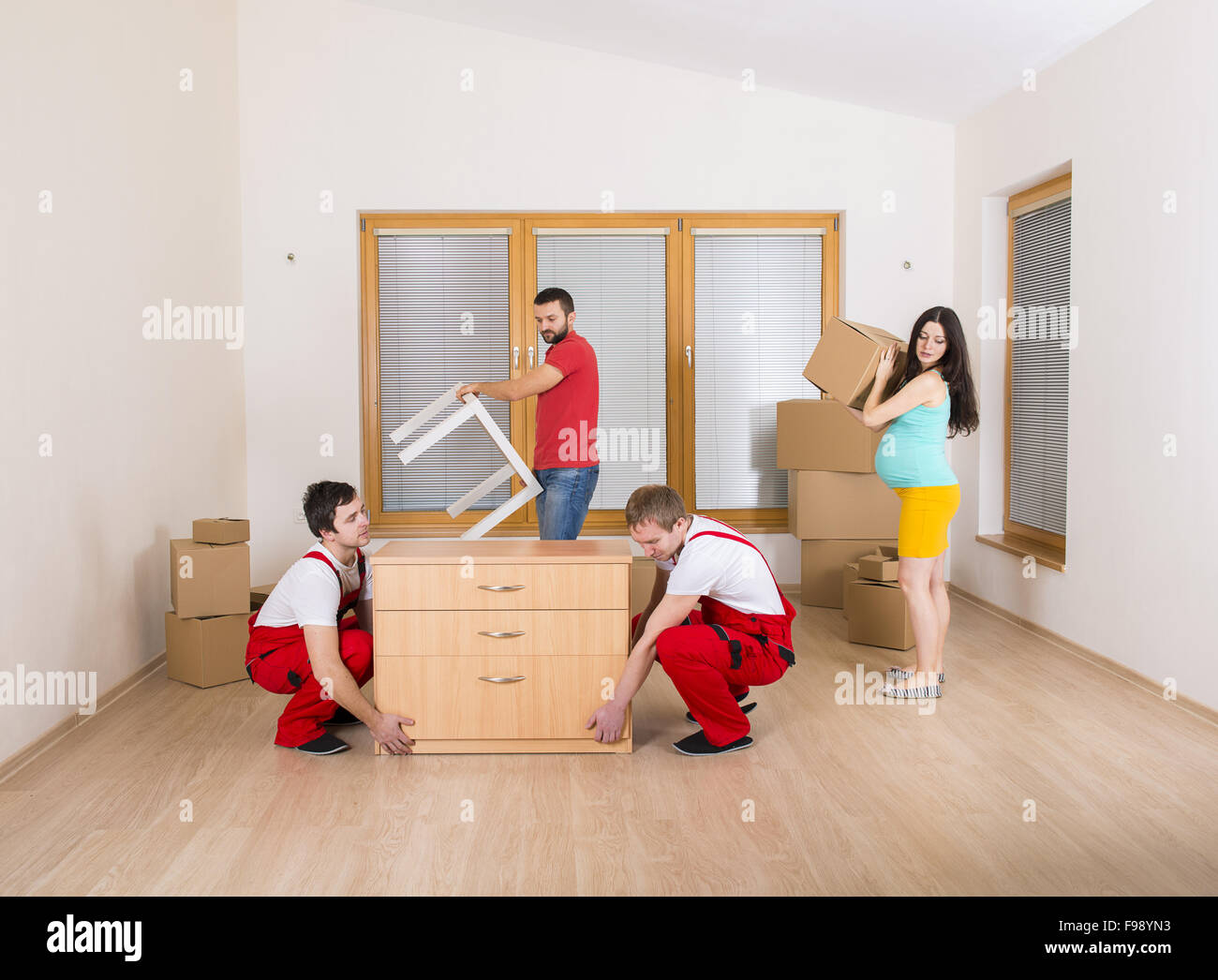 Movers in new house with young family Stock Photo