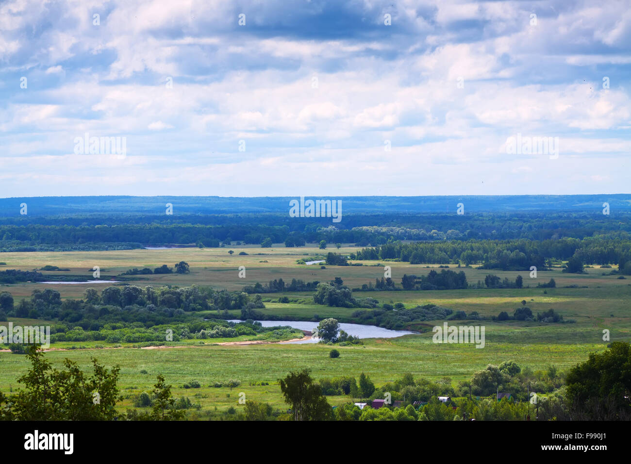 Summer landscape with green meadow under cloudy sky Stock Photo - Alamy