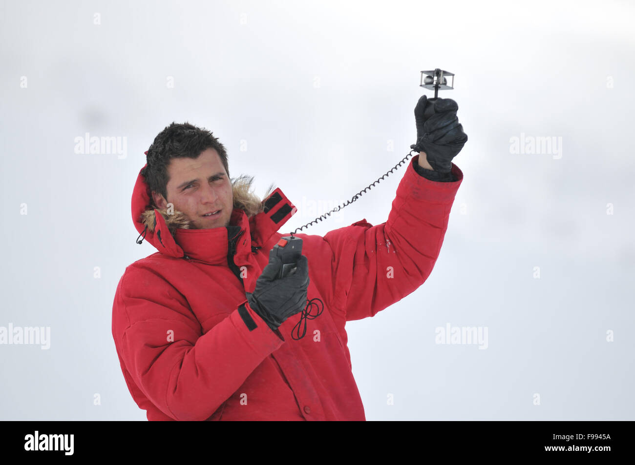 young weather meteo man measure wind speed at winter season Stock Photo
