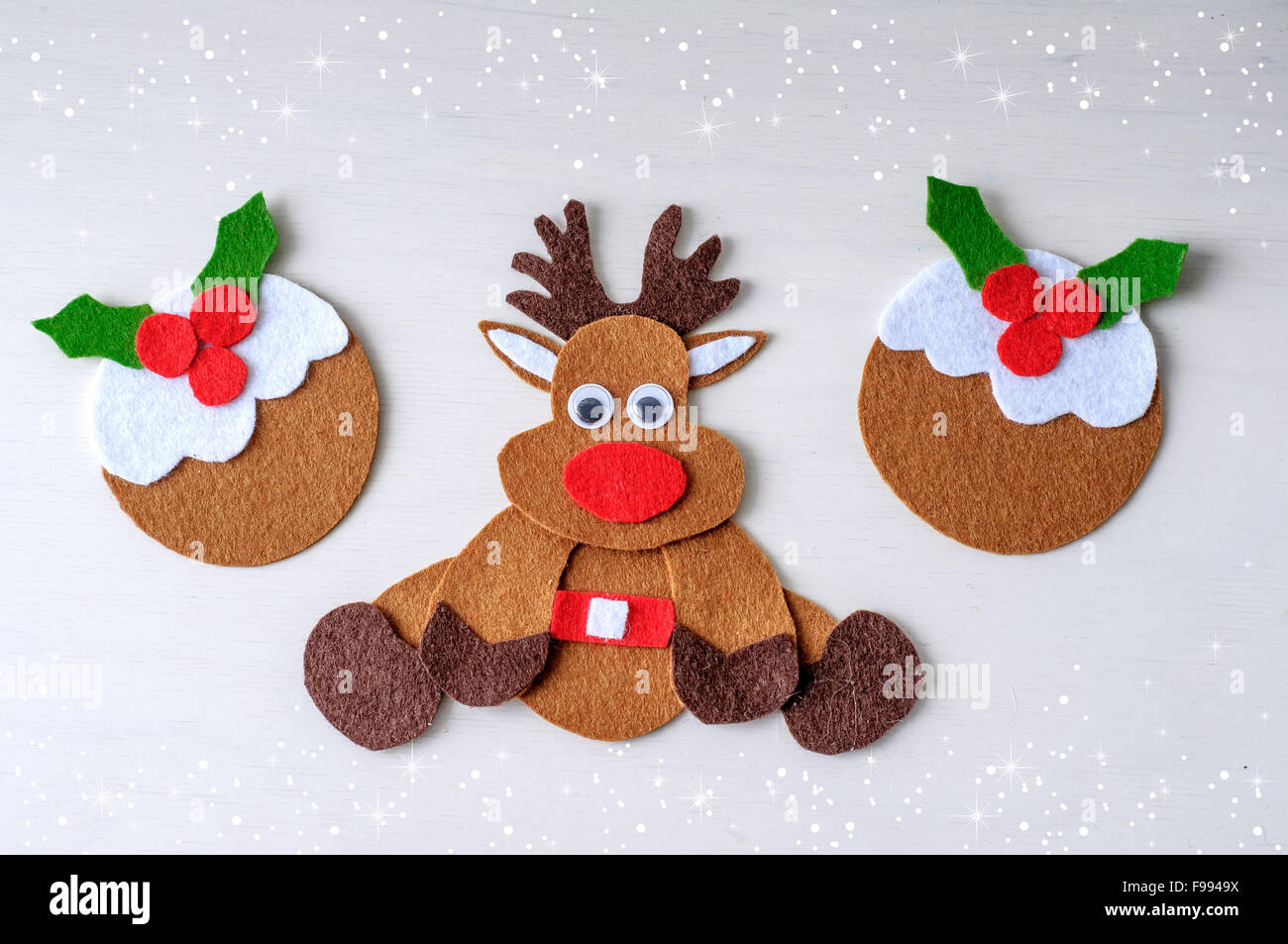 greeting card handmade christmas rudolph reindeer from felt with christmas pudding in the  winter time Stock Photo