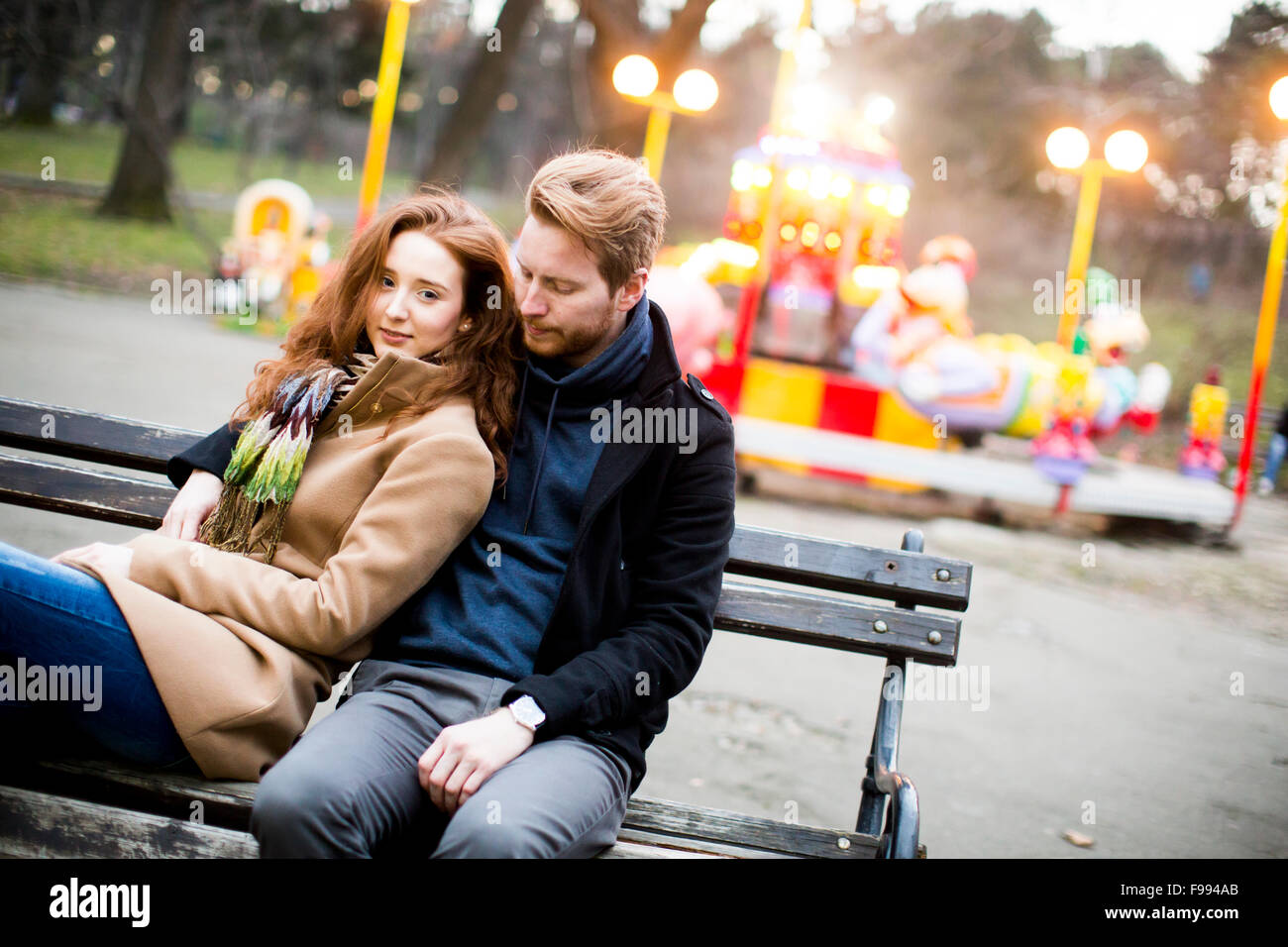Young couple in the amusement park Stock Photo - Alamy