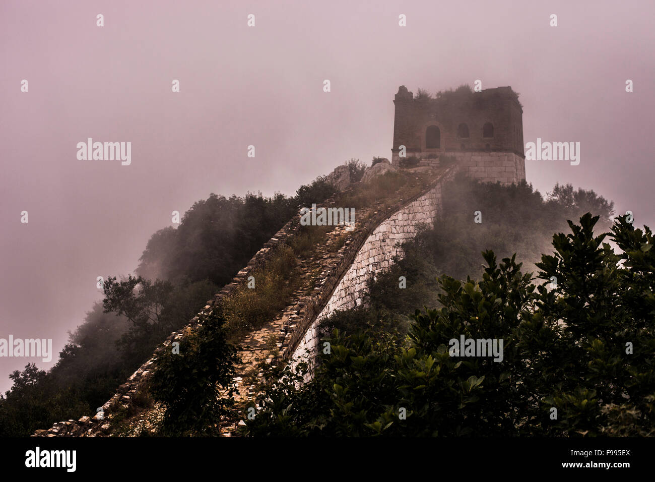 Mountains and the Great Wall of China covered in mist and clouds Stock Photo