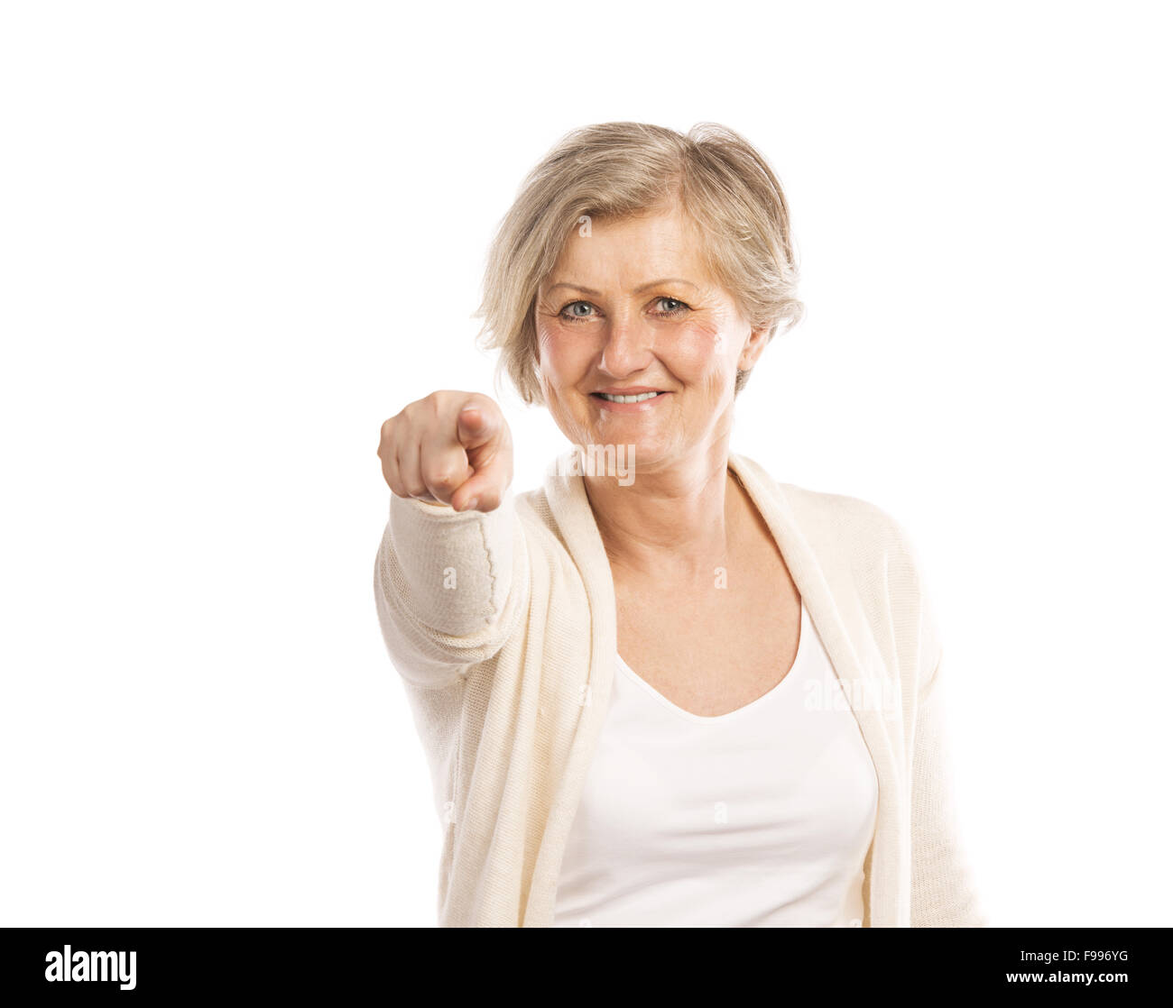 Portrait of a happy senior woman pointing to the camera, isolated on a white background Stock Photo