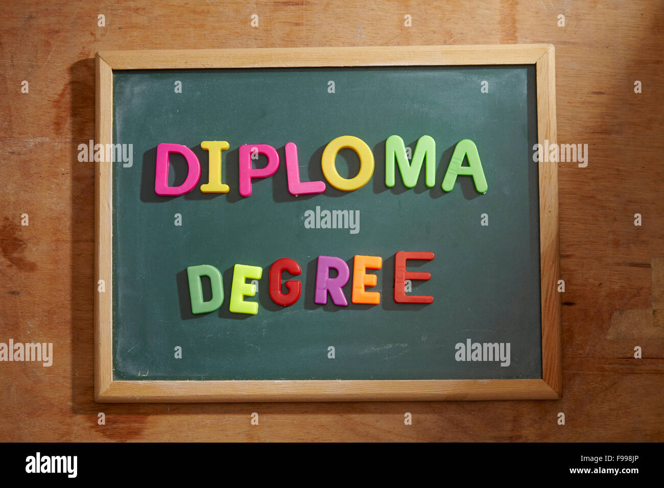 words diploma and degree on the chalkboard Stock Photo