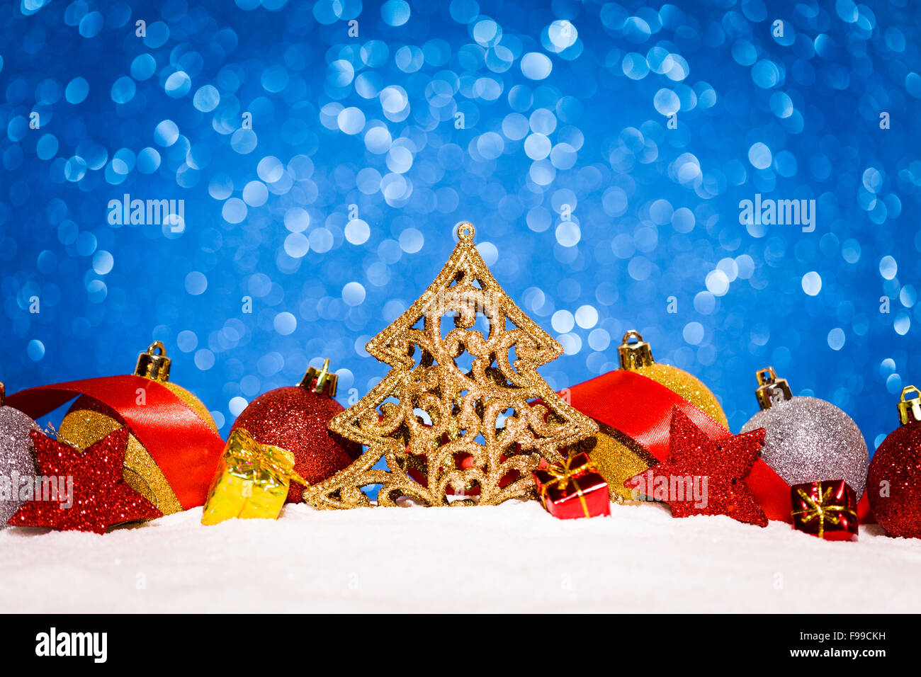 christmas ornament in snow on glitter background Stock Photo - Alamy