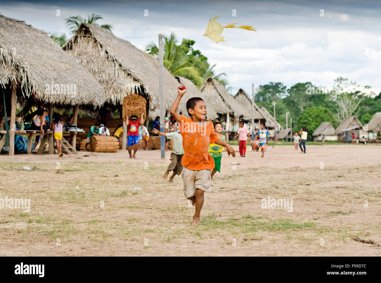 Kid flies a kite ,Manco Capac, Shipibo tribe village, Amazon , Pucallpa district Peru Stock Photo