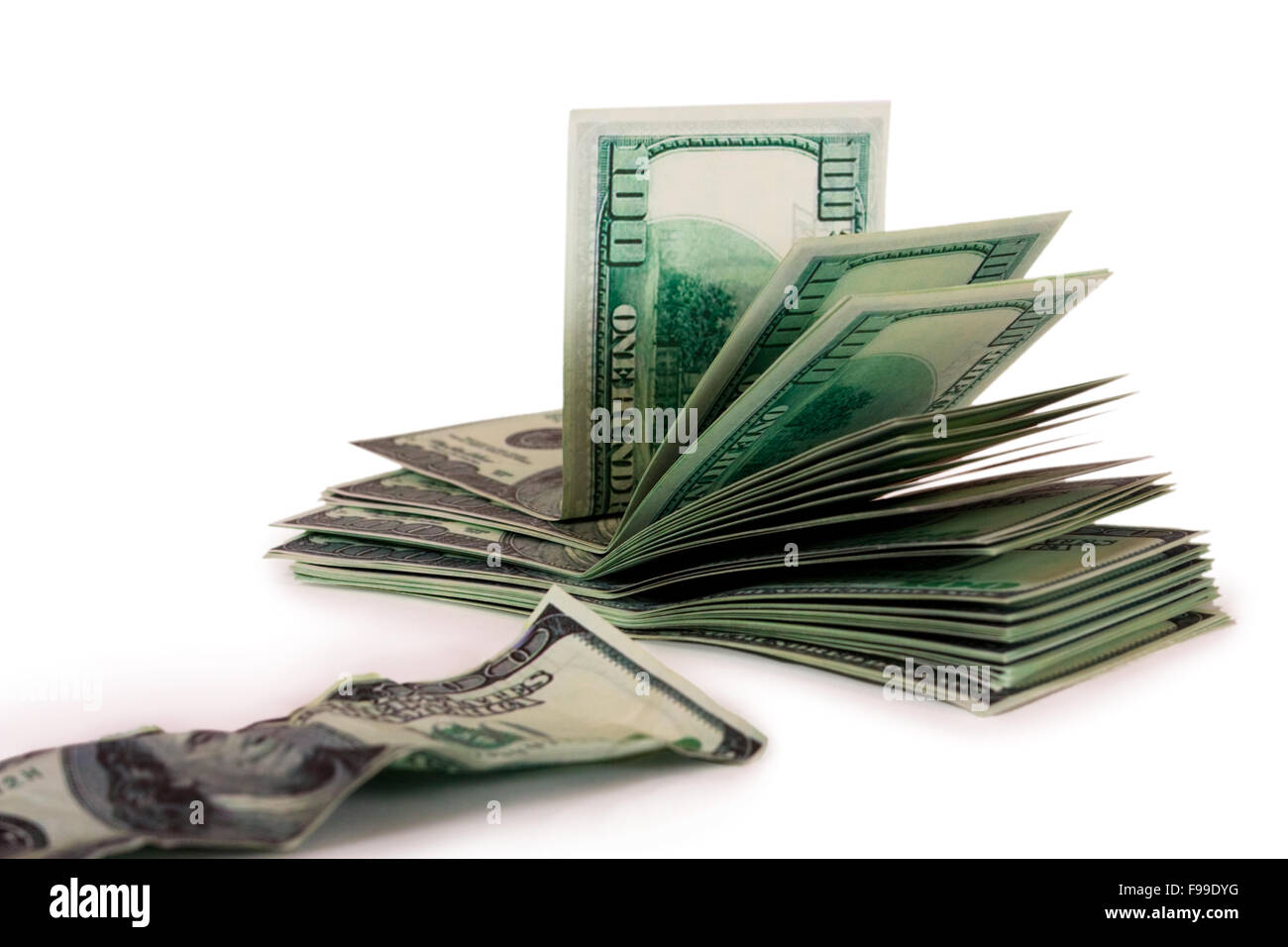 A pile of hundreddollar bills and the old bill isolated on a wh Stock