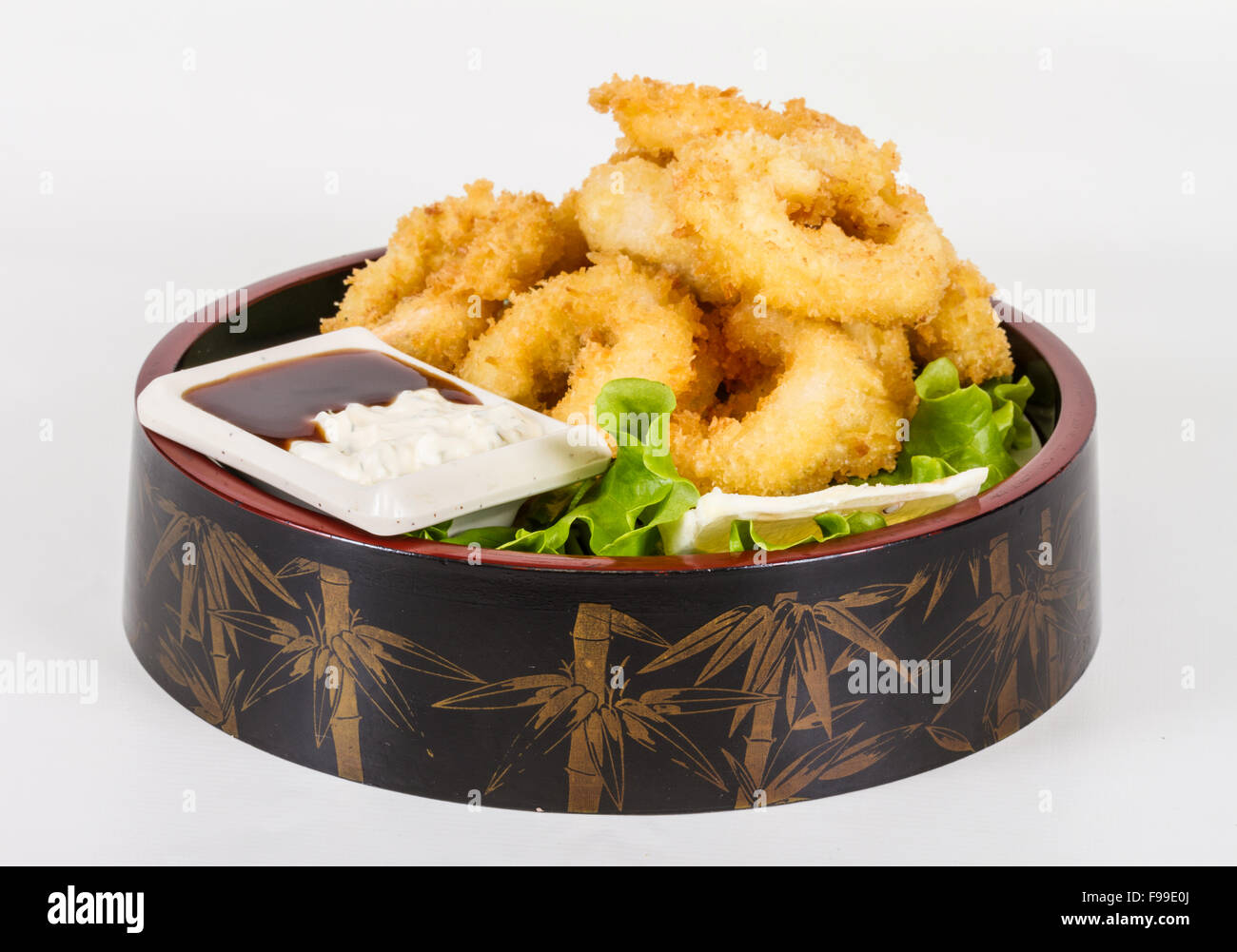 Deep batter fried squid rings calamari with green salad Stock Photo - Alamy