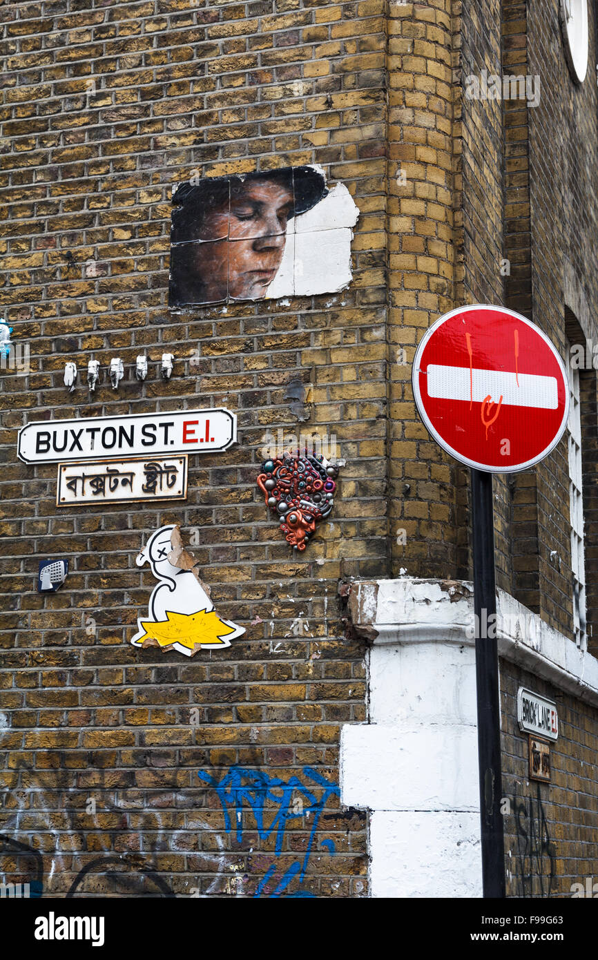 Street art on a brick wall in Buxton Street, Shoreditch, in the Borough of Tower Hamlets Stock Photo