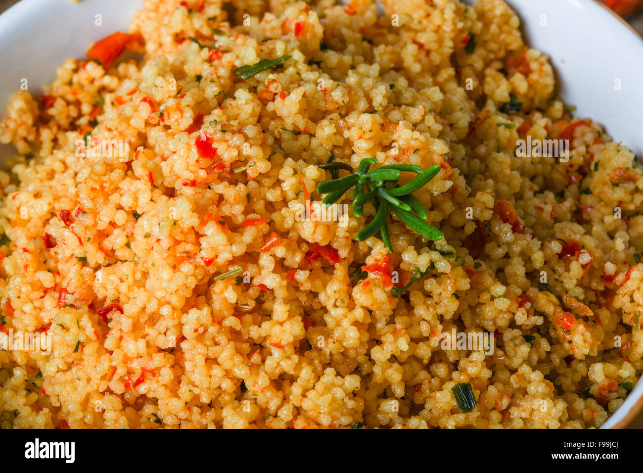 Arabic traditional cuisine Couscous with tomato and green onion Stock