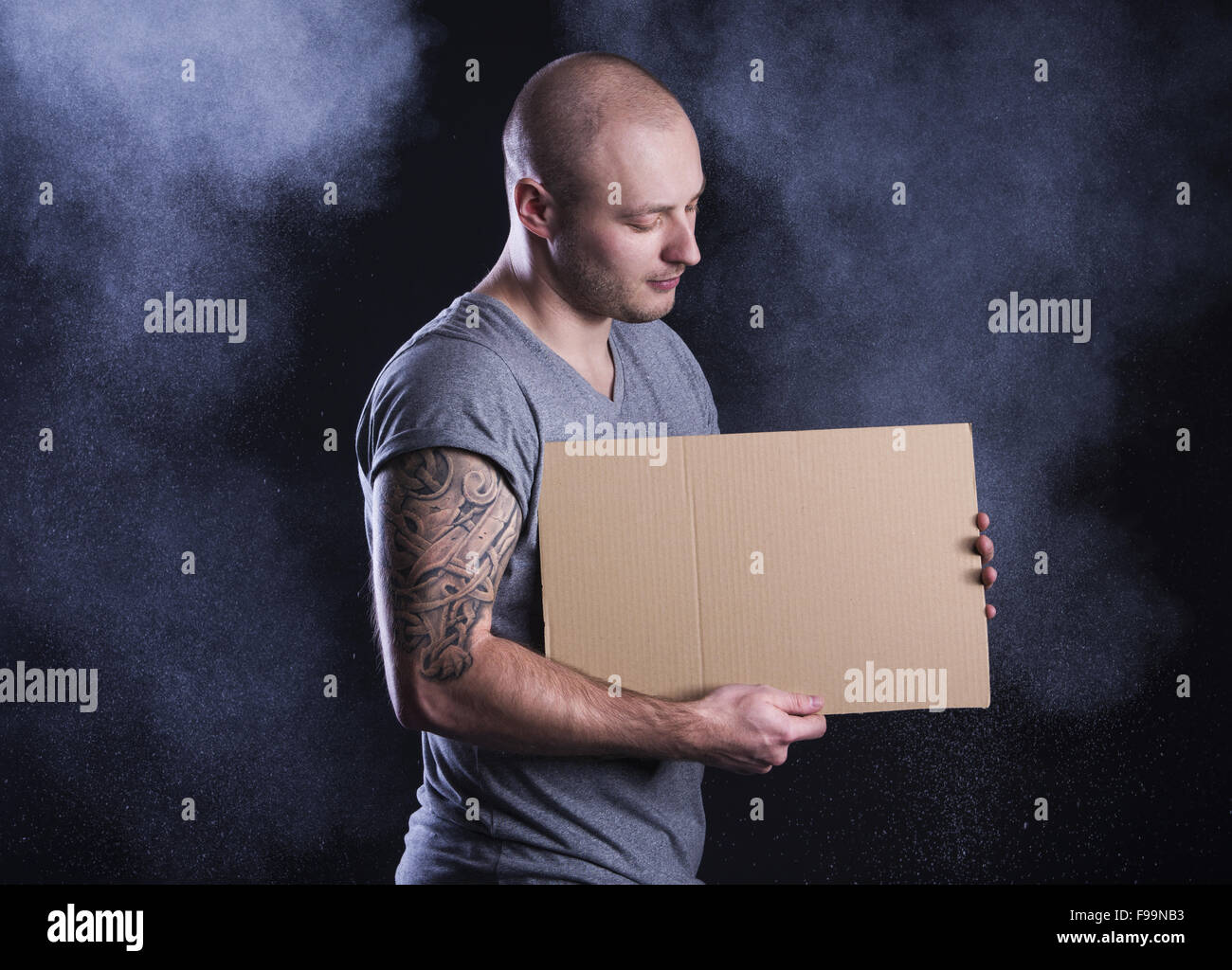 Handsome young man with tattoo, isolated on black Stock Photo - Alamy