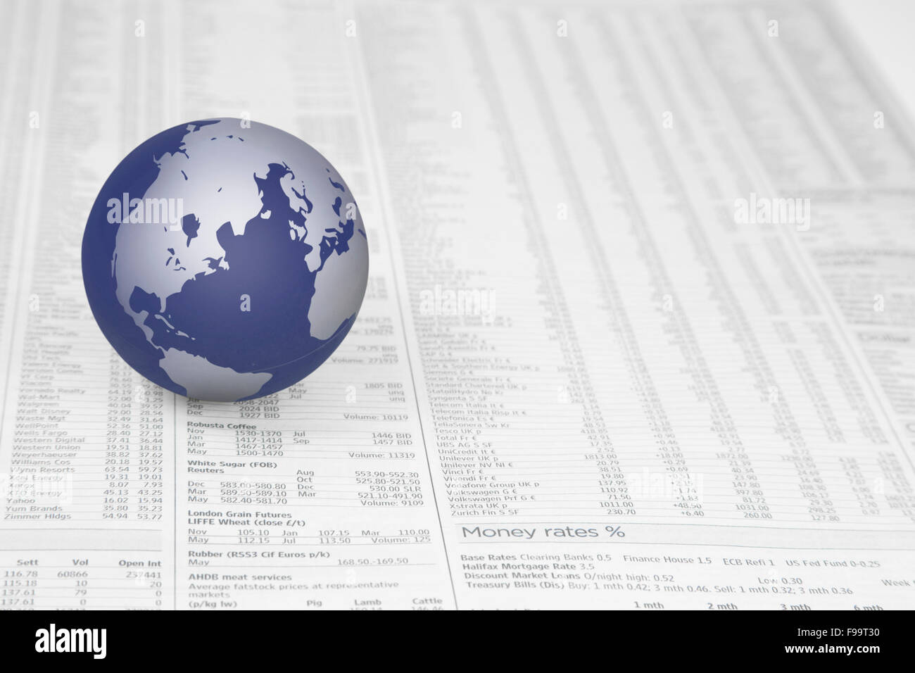 Map of the world globe on a News paper Stock market financial pa Stock Photo