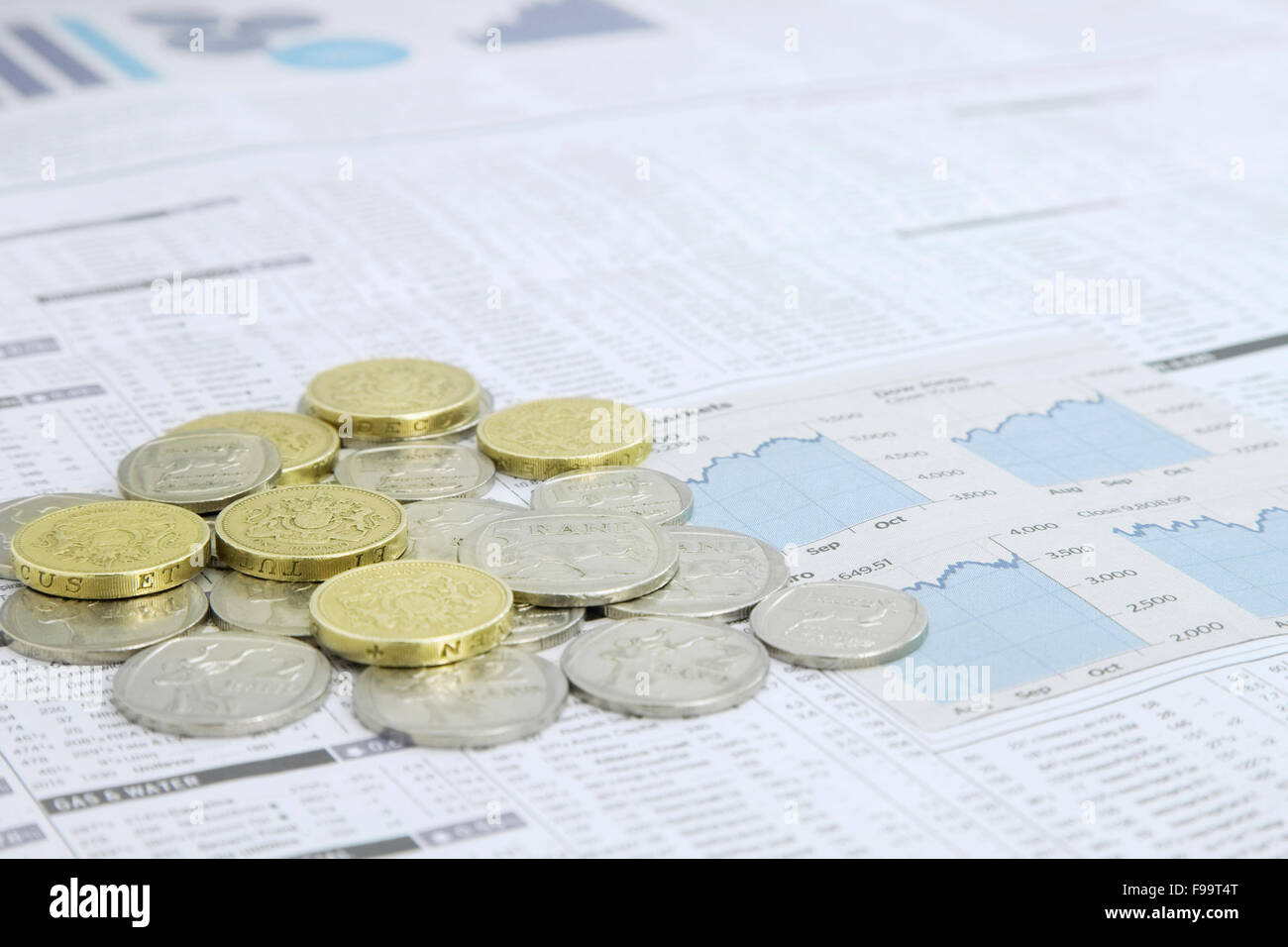 South African Rand And British One Pound Coins on a on a News pa Stock