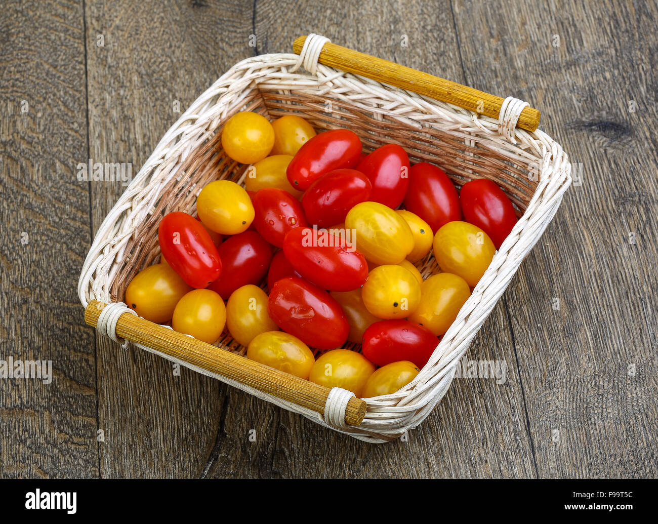Yellow and red cherry tomatoes mix on the basket Stock Photo - Alamy