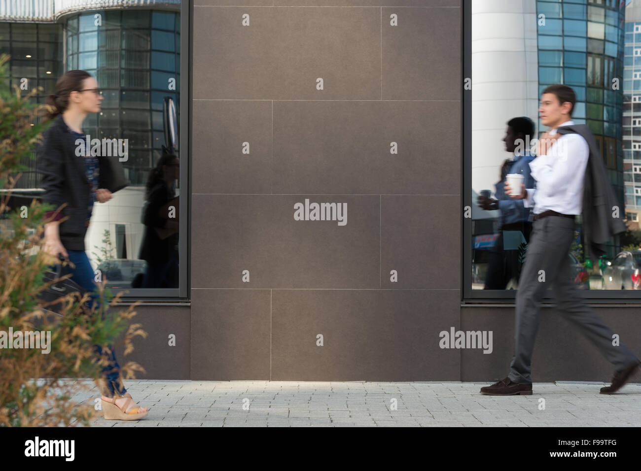 Two businesspeople walking on the street near office building Stock Photo