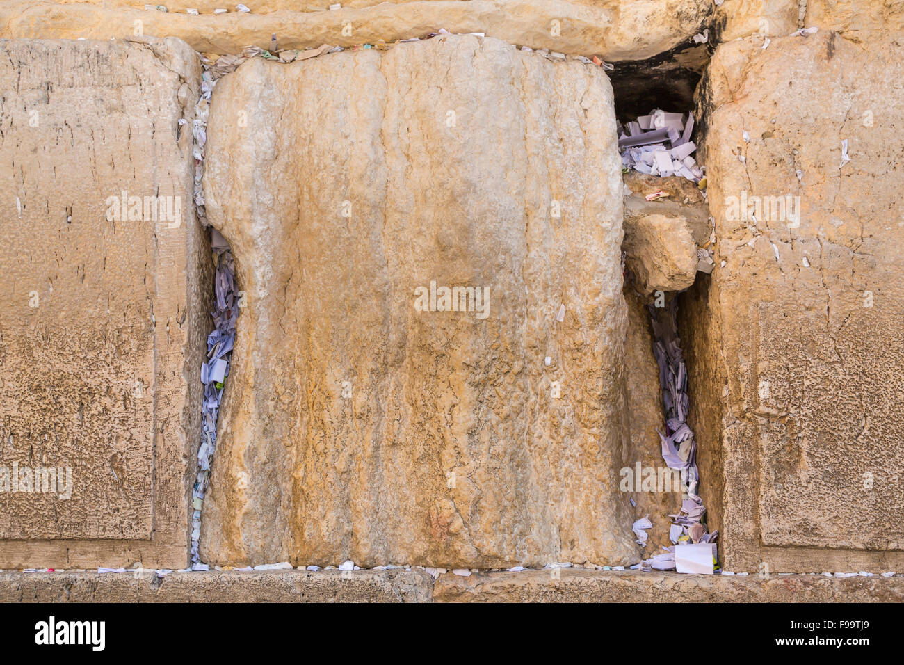 Prayers written on paper stuck into cracks in the Western Wall in Jerusalem, Israel, Middle East. Stock Photo