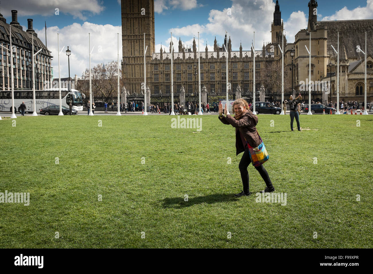 Tourists taking photos in Parliament Square with House of Parliament in the background, London, UK Stock Photo