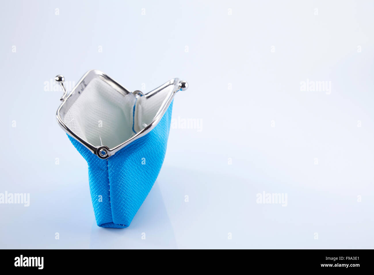 empty blue color purse on the white background Stock Photo - Alamy