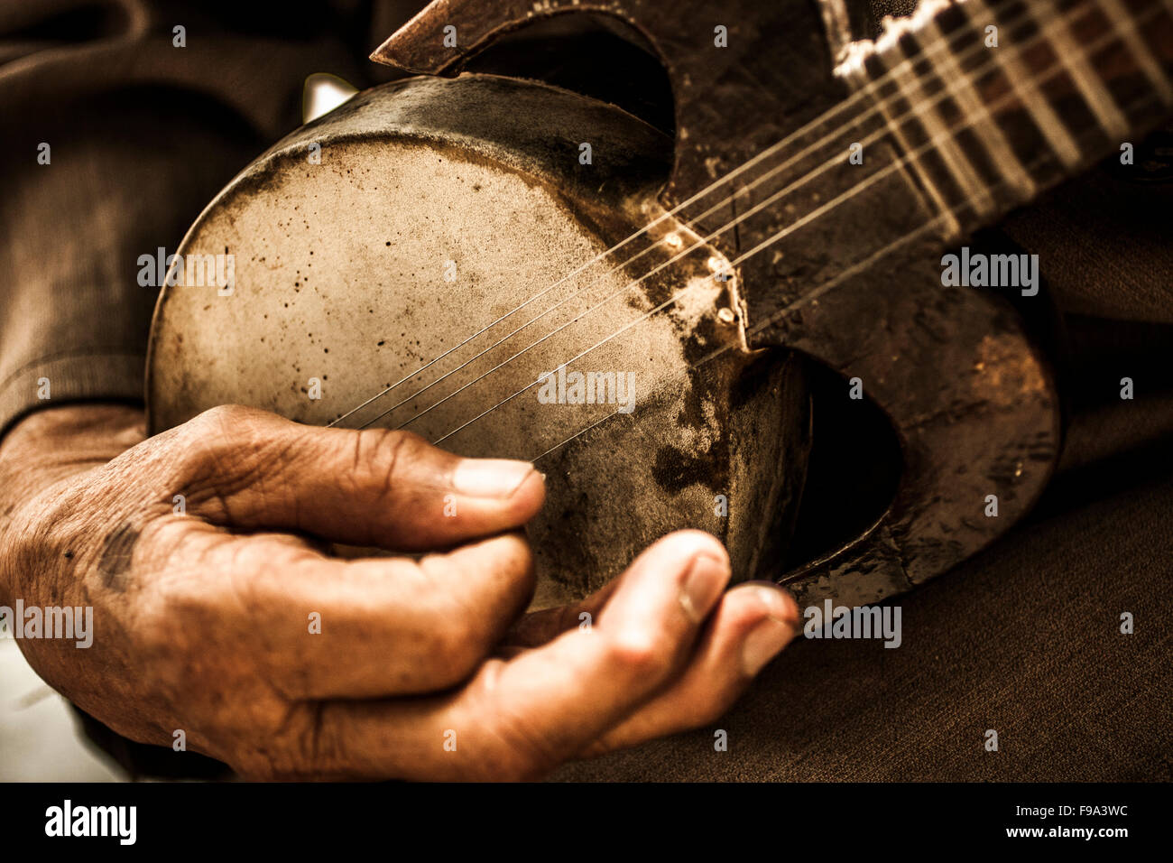 Detail of a man playing a Central Asian instrument. Stock Photo