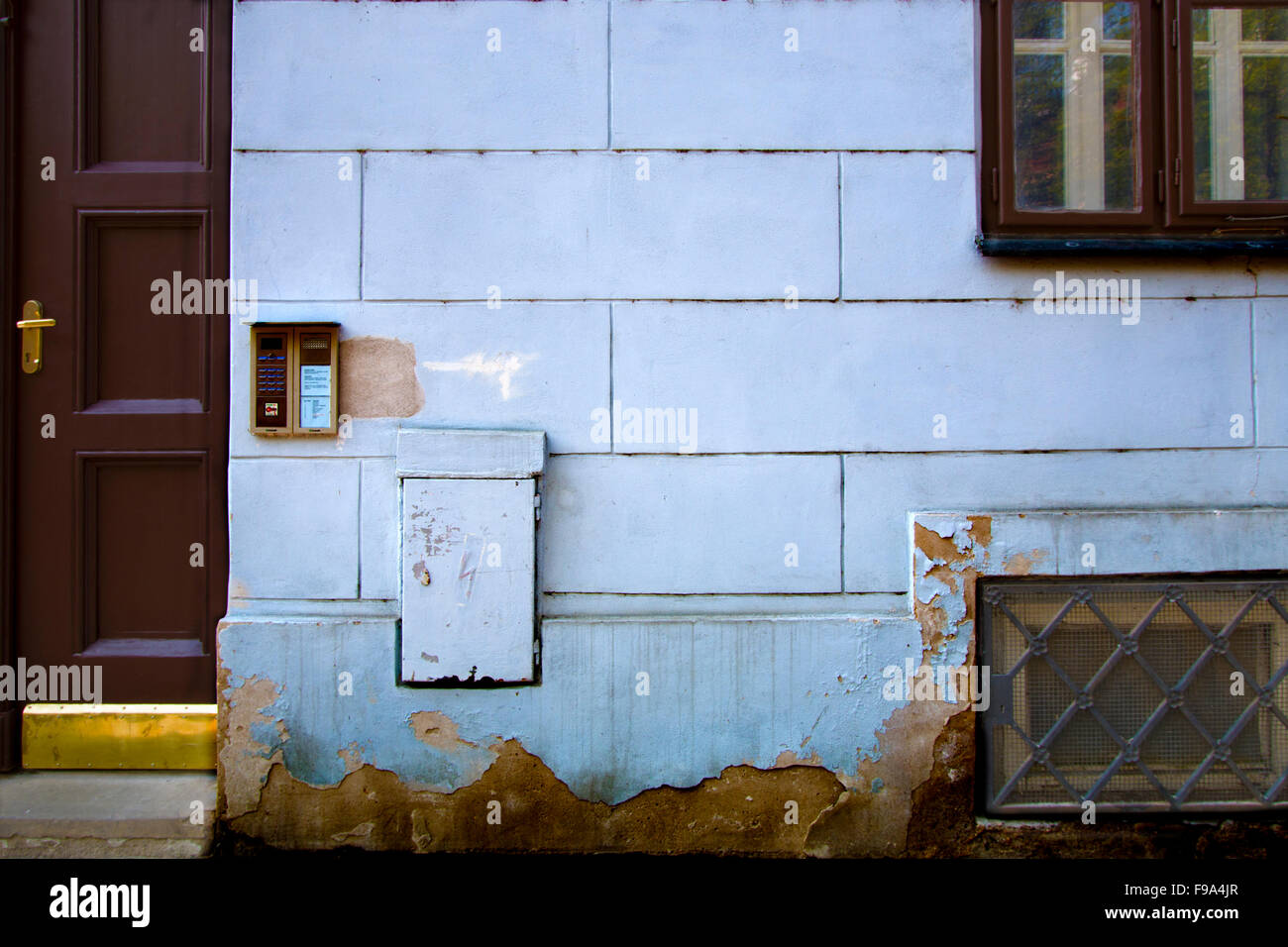 Blue brick building with door, window and basement Stock Photo