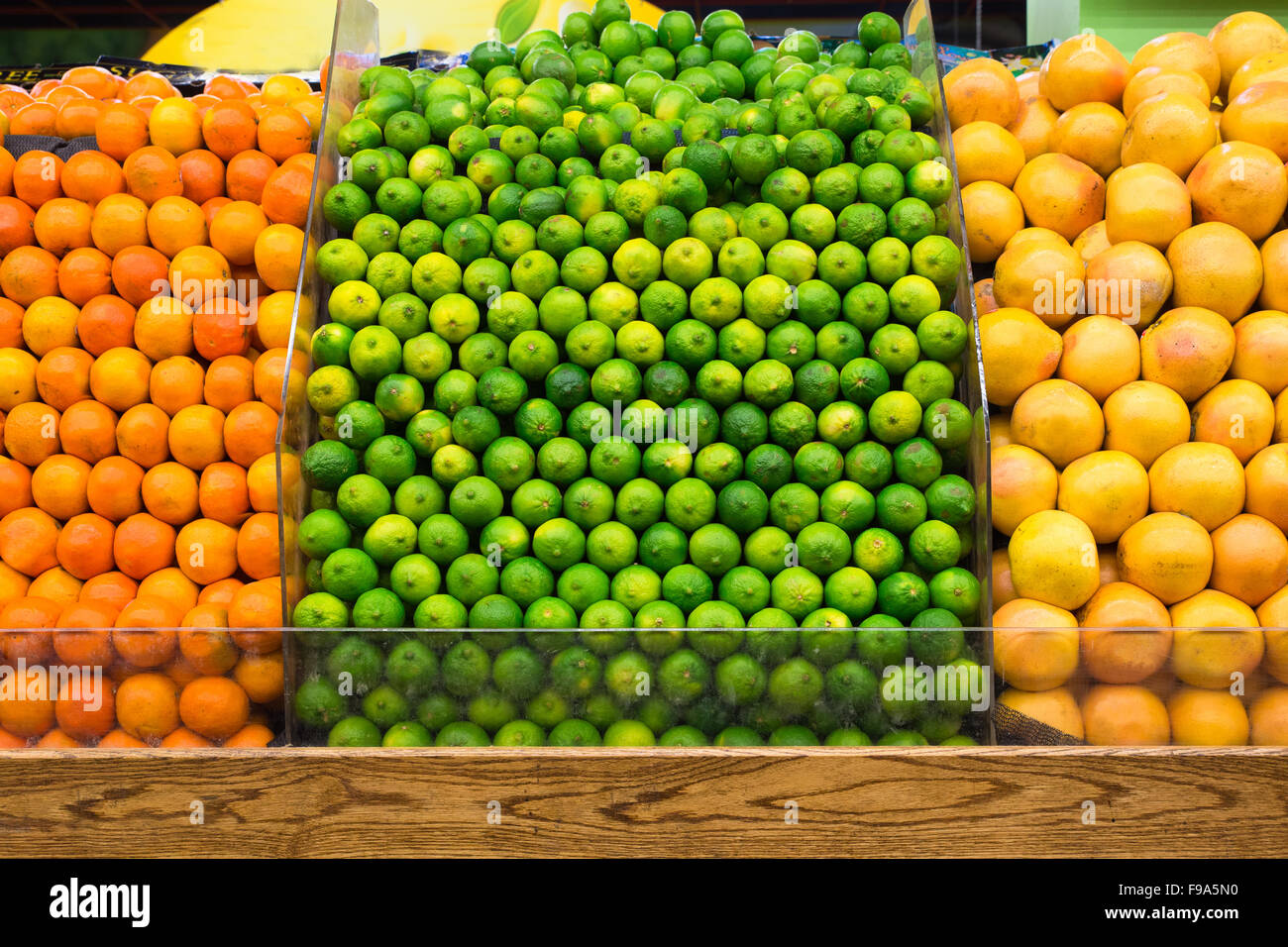 Produce fruit market display of limes, oranges and grapefruit Stock