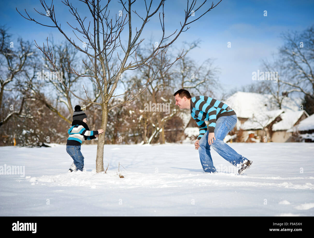 Happy father with son having fun outside in snow Stock Photo Alamy