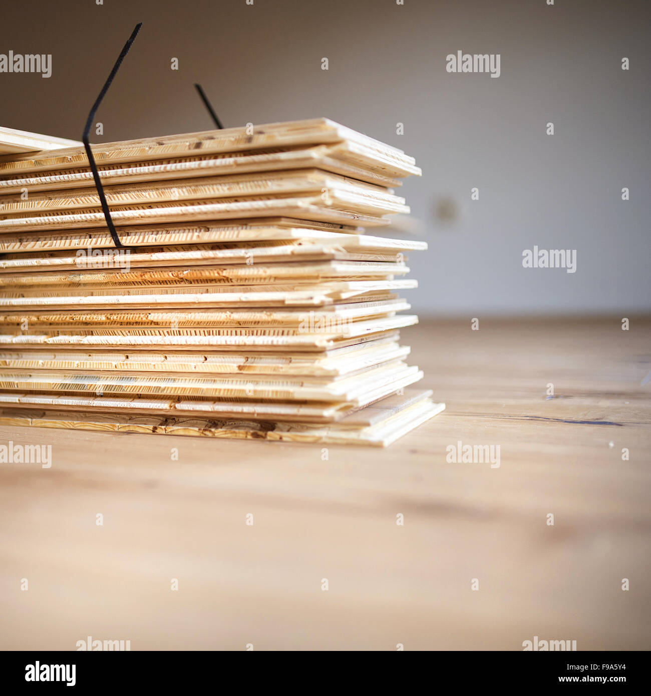 Stack of plywood ready for floor installation in new house Stock Photo