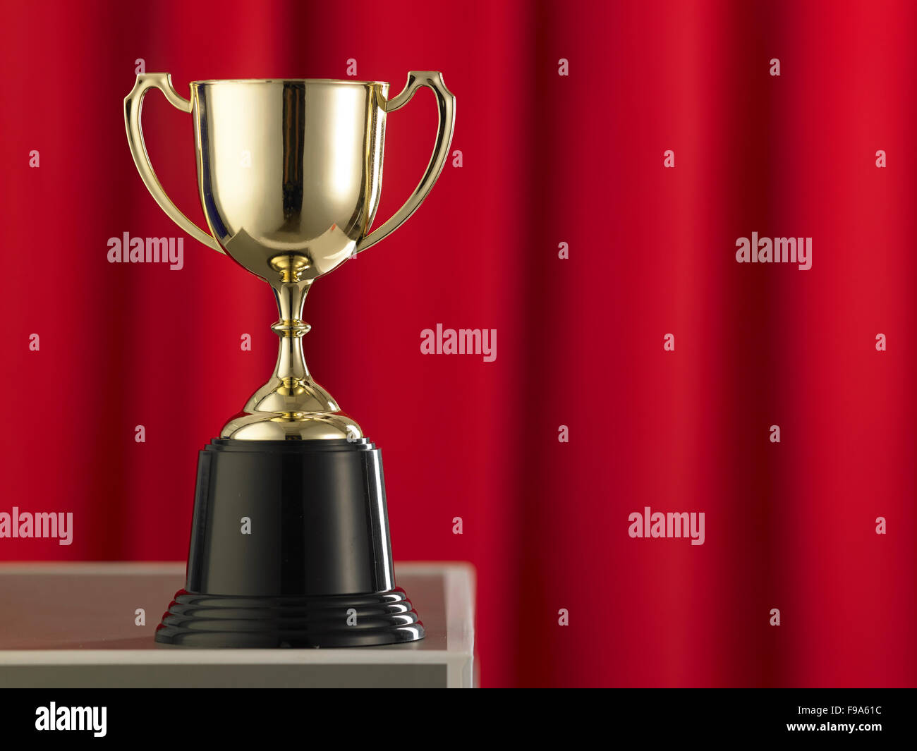 trophy in front of the red curtain Stock Photo - Alamy