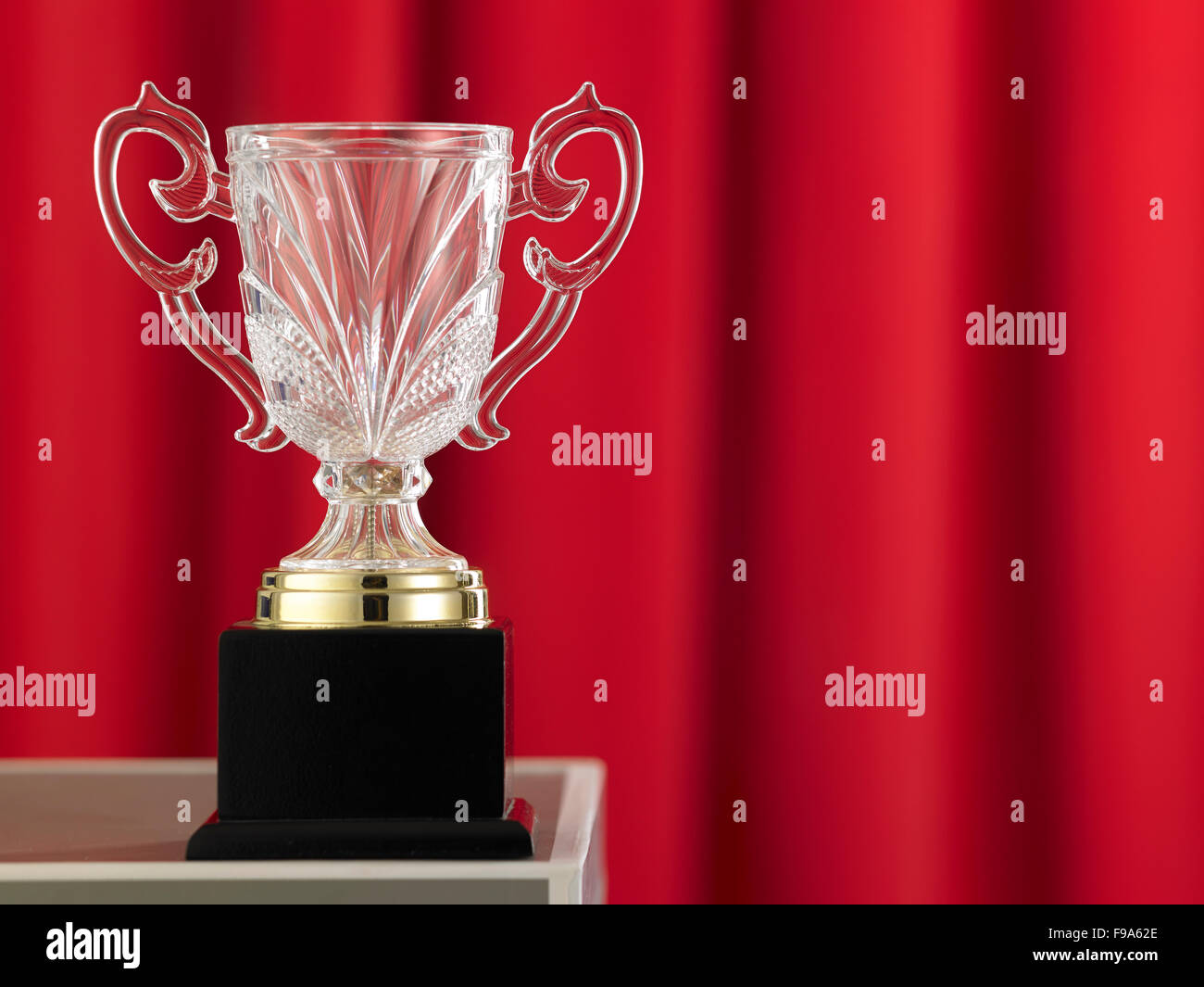 trophy in front of the red curtain Stock Photo - Alamy