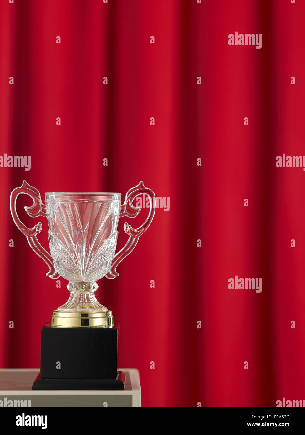 trophy in front of the red curtain Stock Photo - Alamy