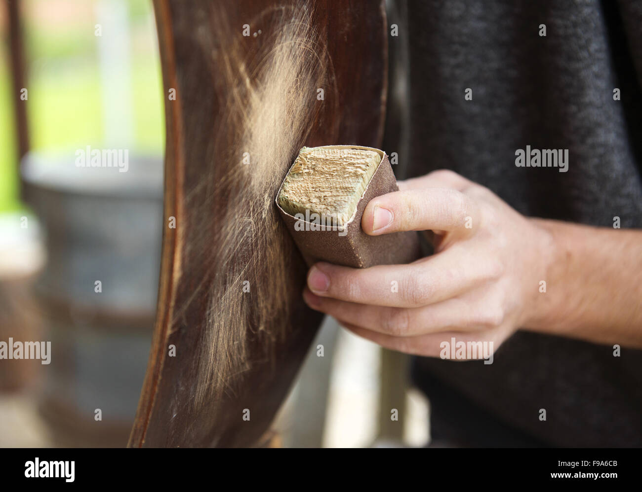 Restoration, removing paint from antique chair with sandpaper Stock