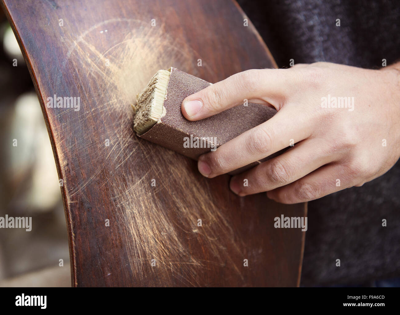 Restoration, removing paint from antique chair with sandpaper Stock