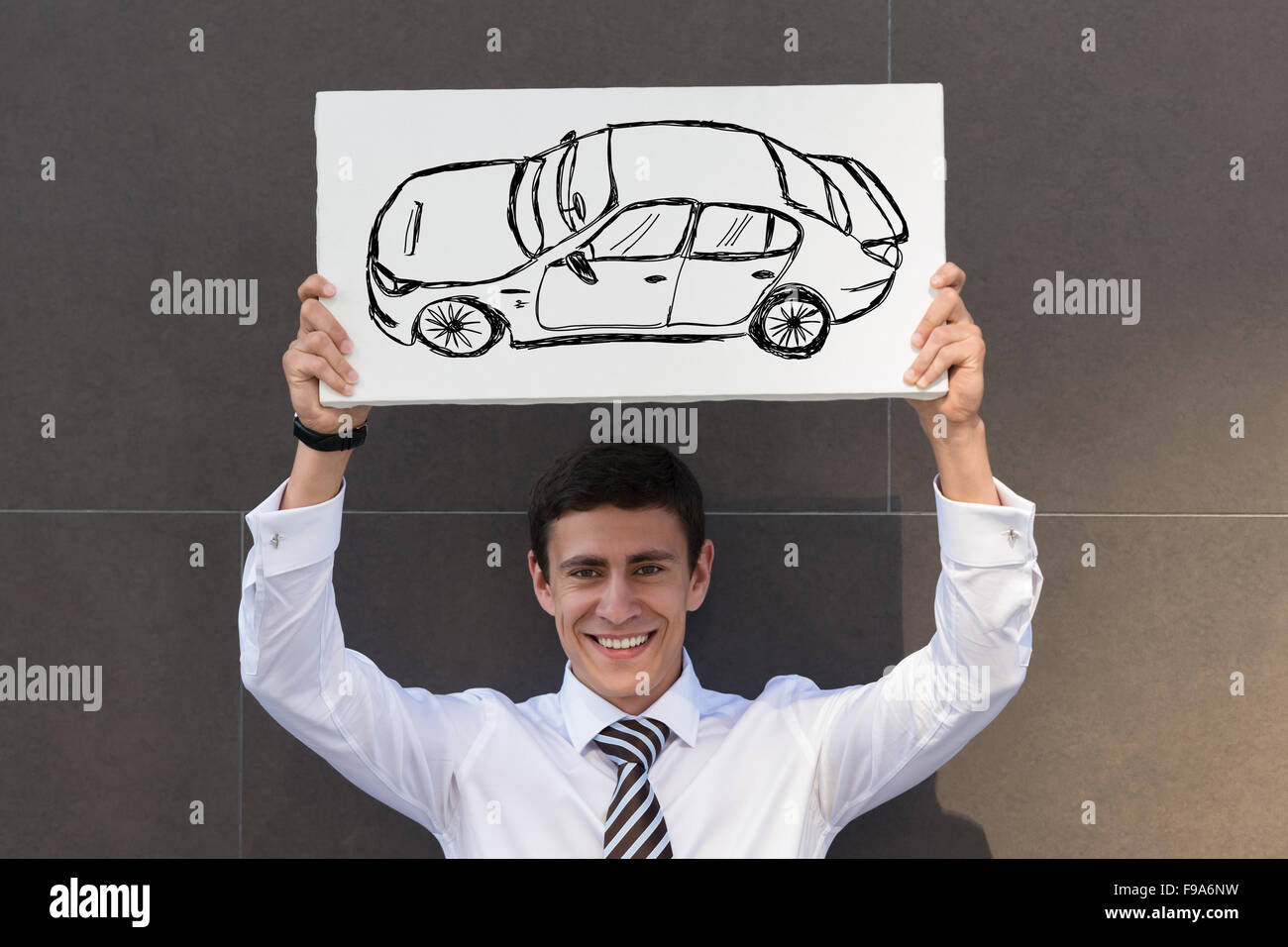 Business man with new car sign. Dealer or buyer showing car sign. Credit concept Stock Photo
