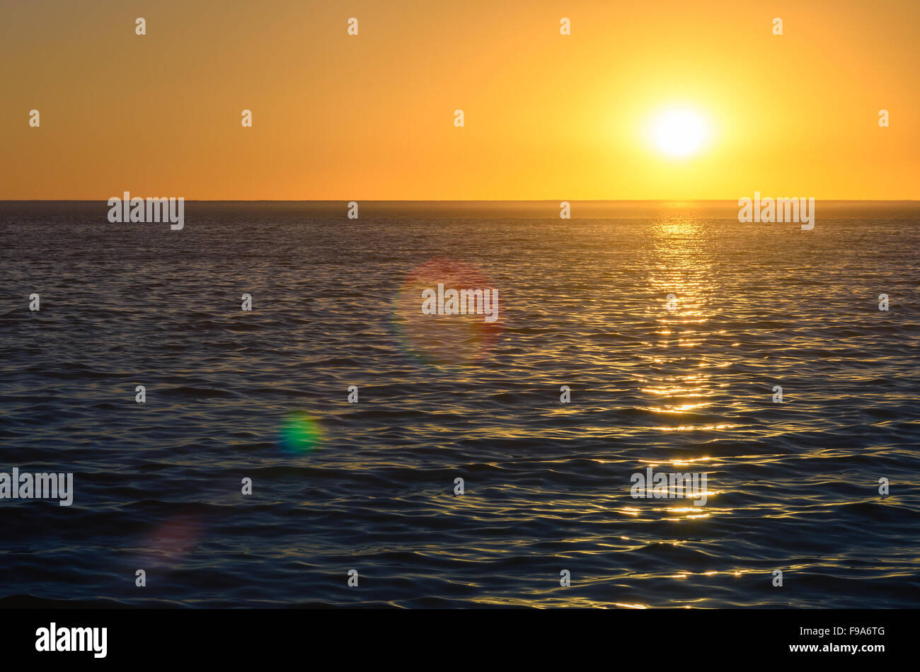 Beautiful sunset at Glenelg Beach with lens flares, South Australia Stock Photo