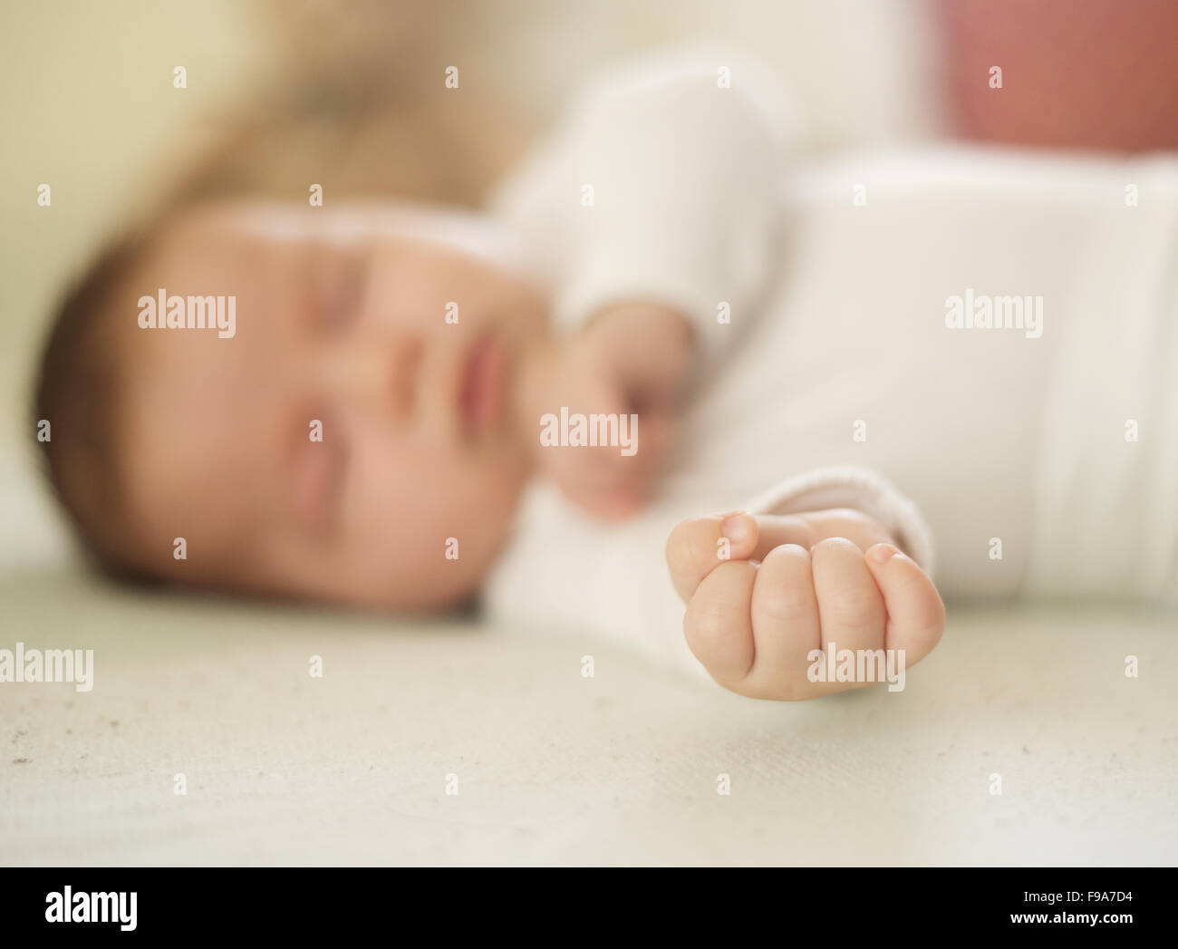 Newborn baby girl is sleeping on the bed Stock Photo Alamy