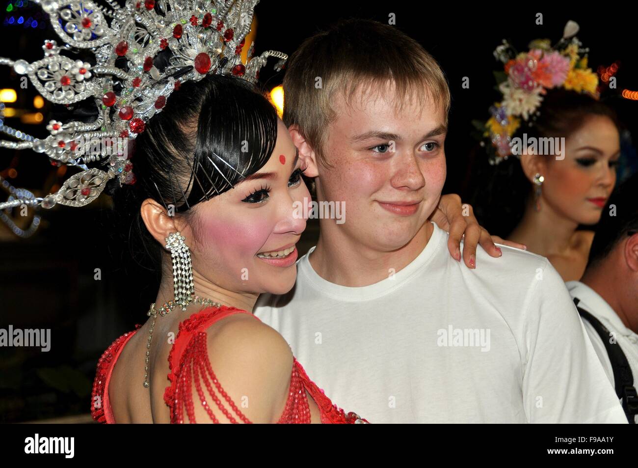 Pattaya, Thailand:   Russian teenager poses with a dazzling ladyboy showgirl following a performance of the Tiffany's show Stock Photo